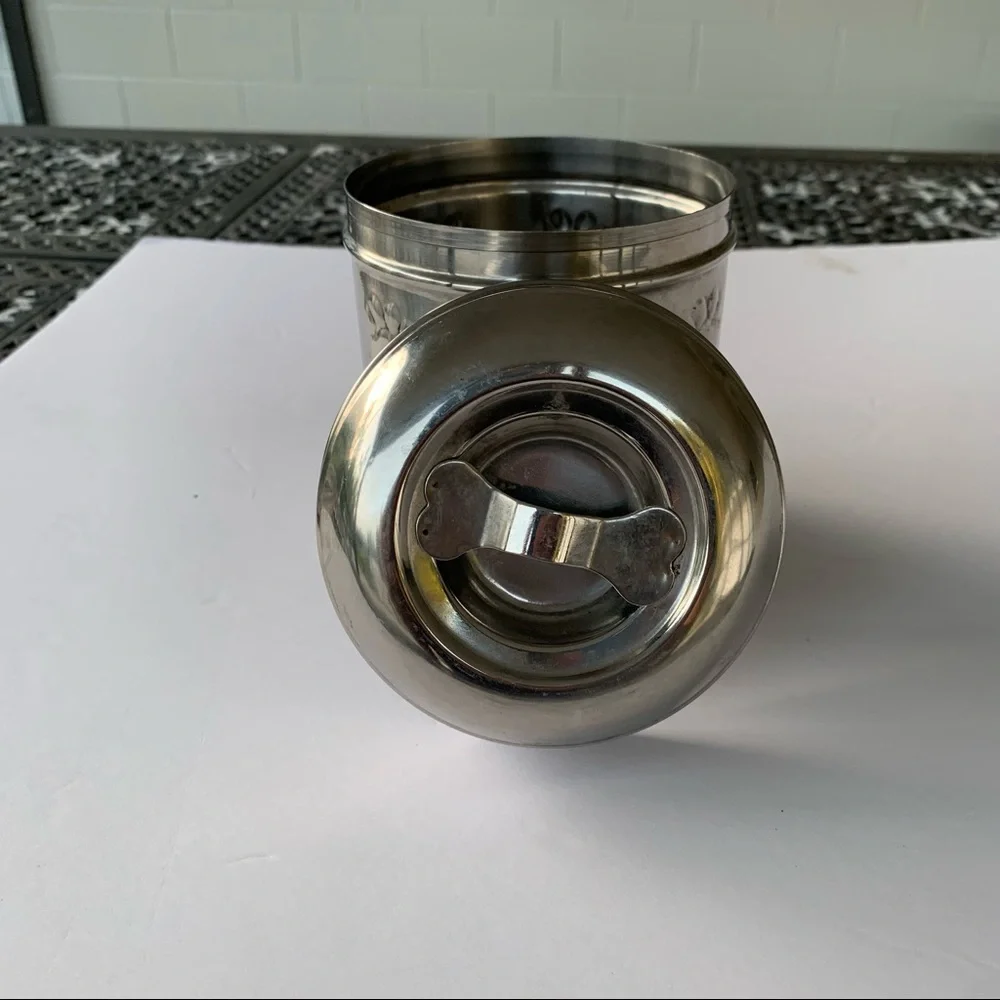 Dog treat canister with paw prints to keep small dog treats
